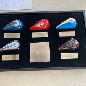 Harley memorabilia in a custom display case. Featuring Vintage Harley gas tanks.